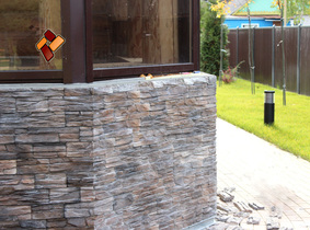 Technology of facing a wooden house with manufactured stone veneer